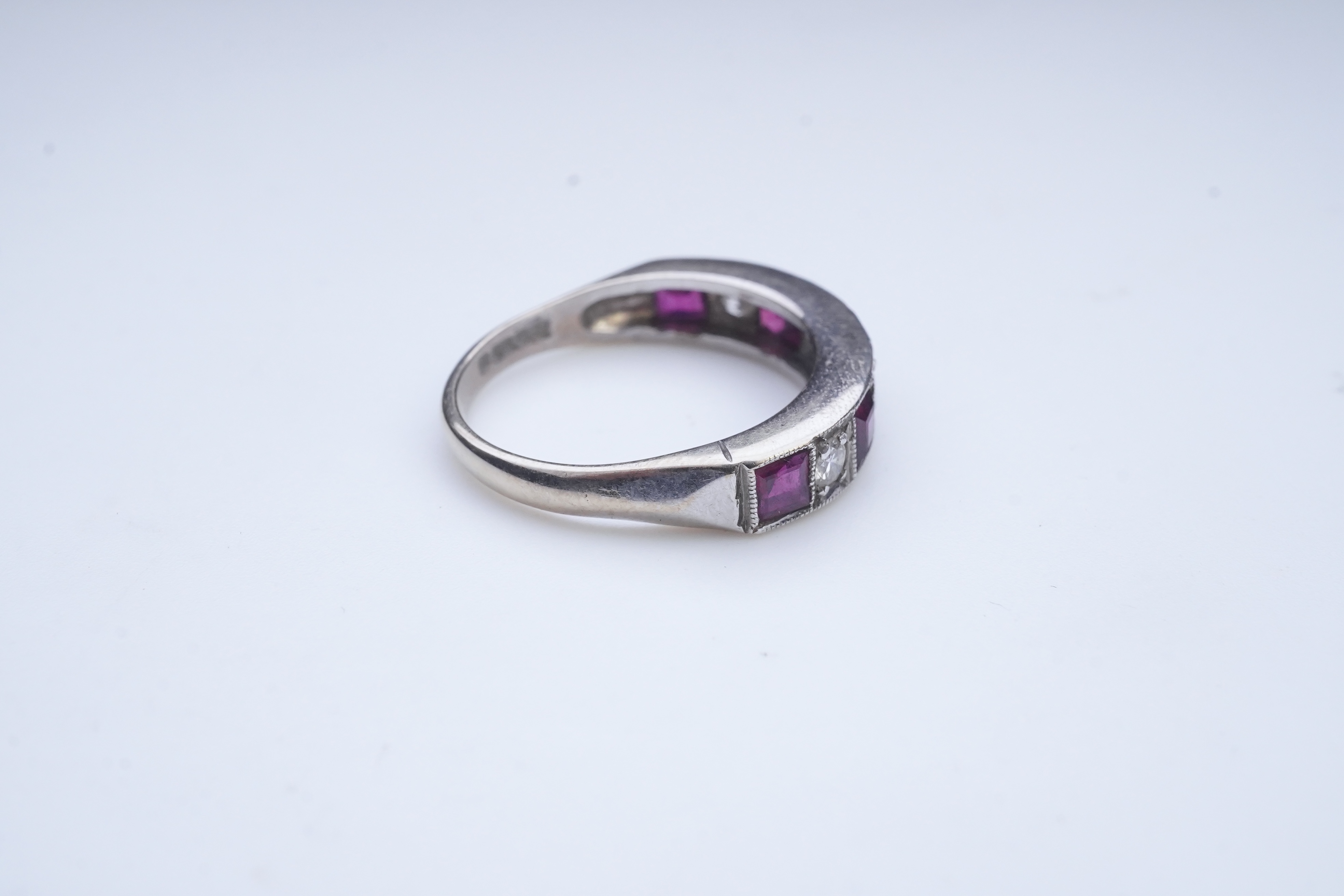 A ruby and diamond half eternity ring